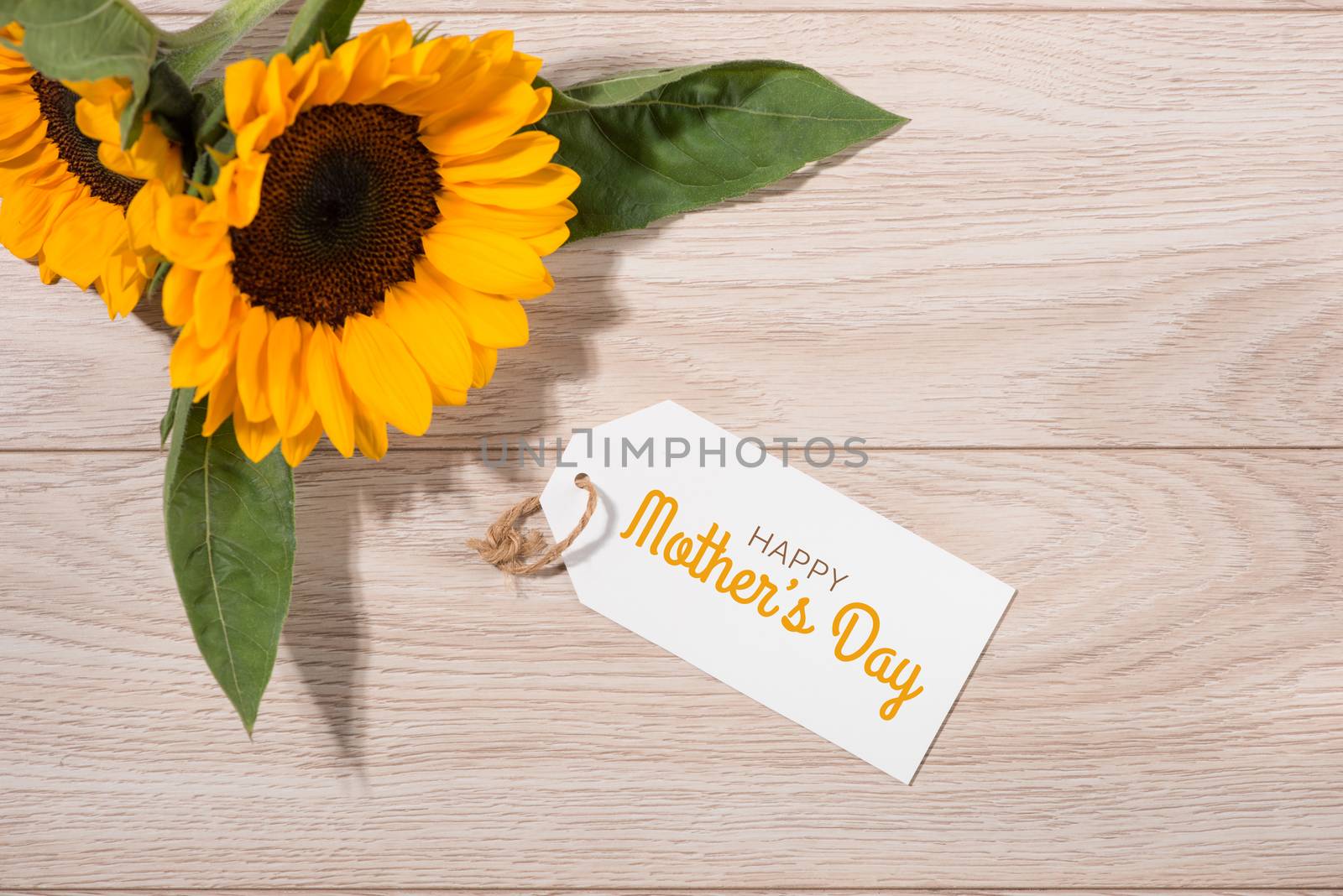 Blank white tag paper with color flowers on wooden background. T by makidotvn