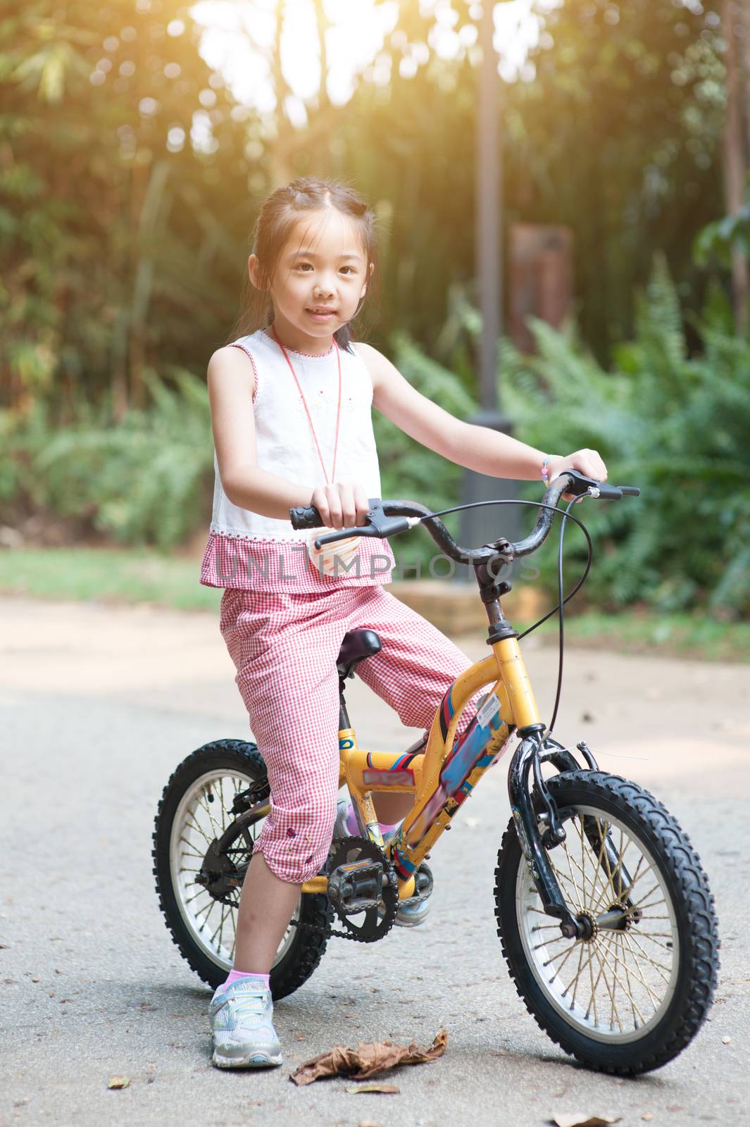 Child cycling outdoor. by szefei