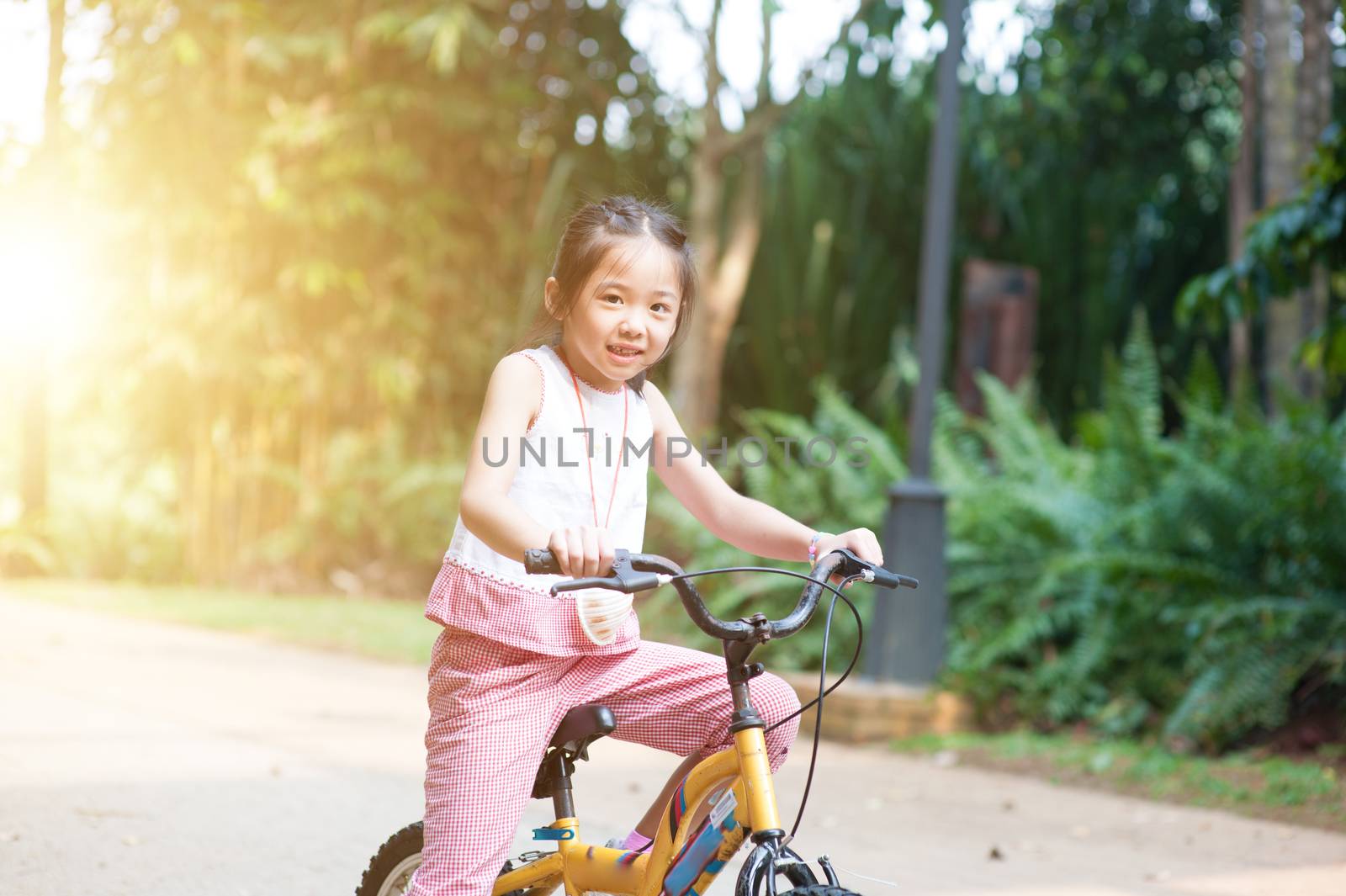 Child riding bicycle outdoor. by szefei