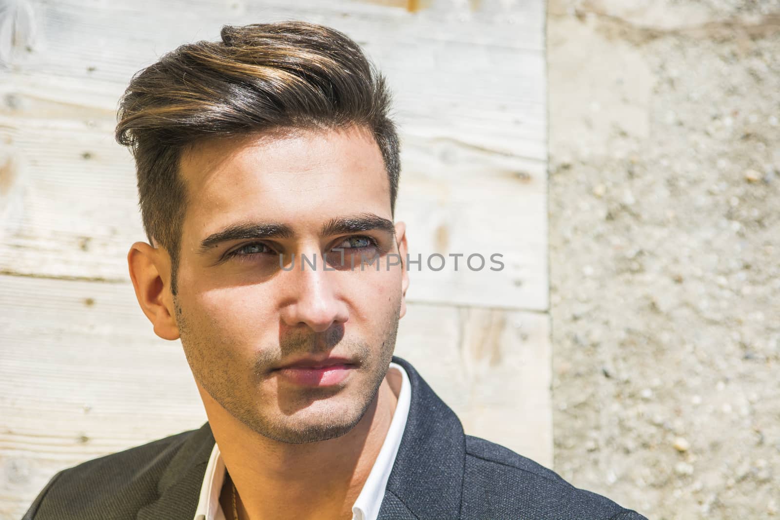 Headshot of handsome young man outdoor in the sun