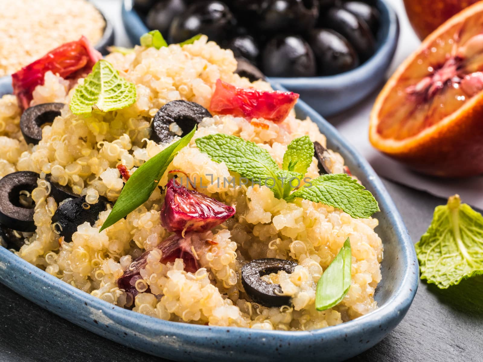 Vegan salad with quinoa, red orange and black olives by fascinadora