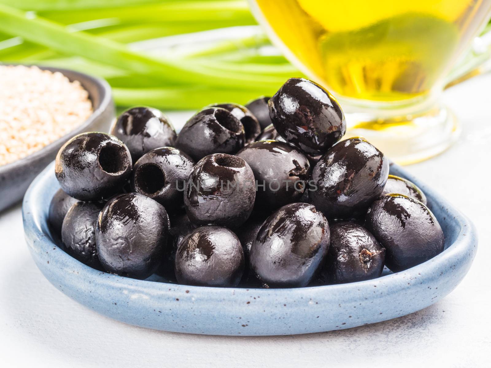 black olives in blue plate by fascinadora