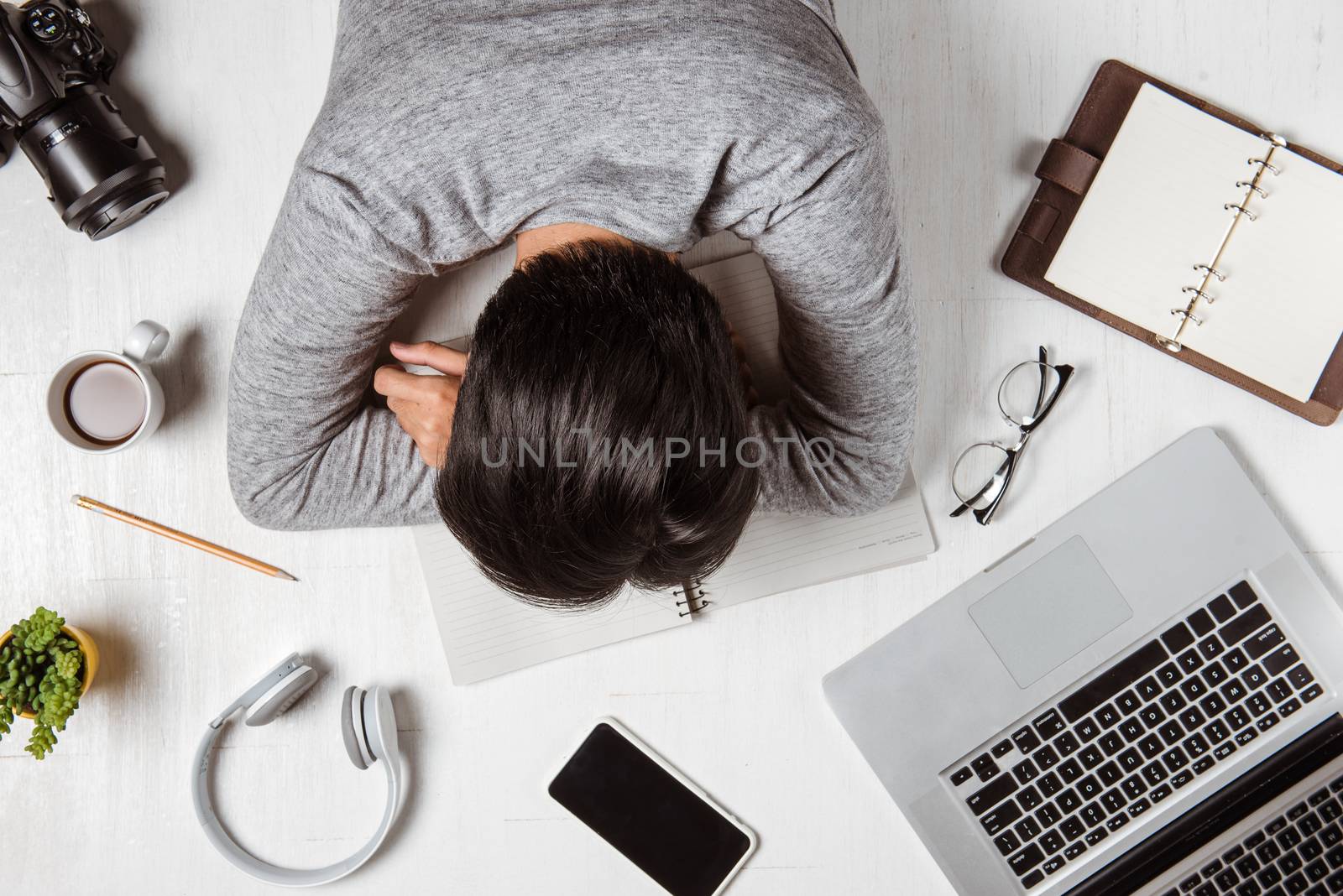 Top view of tired businessman at workplace with copy space