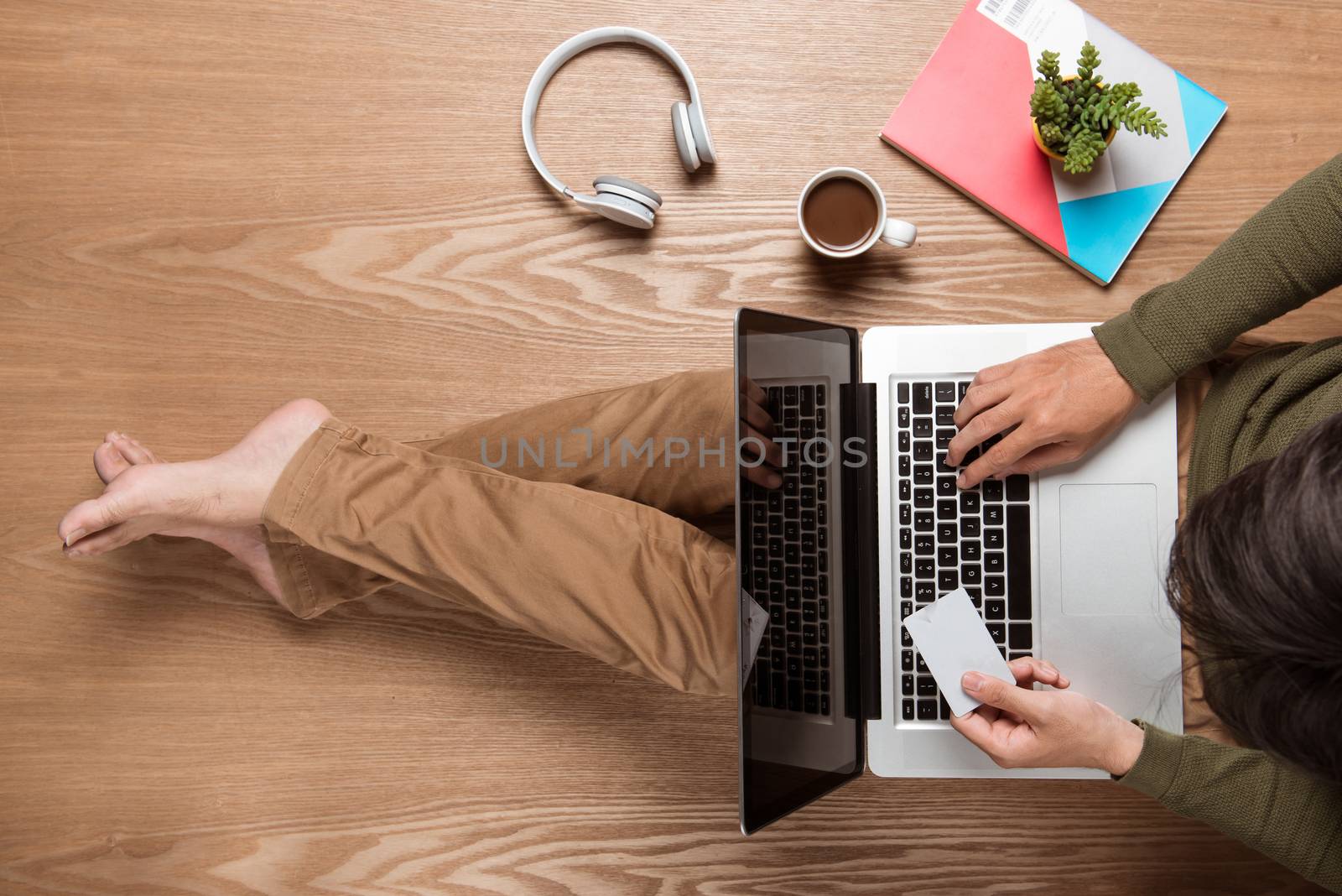 Business man hands using a laptop with a cup of coffee and smart phone with copy space.