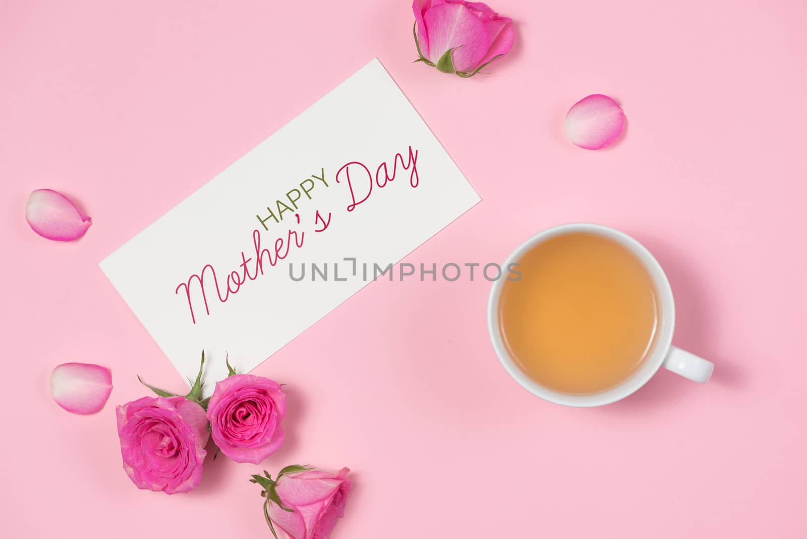 Womans Day greeting card with rose flowers over wooden background. Top view with copy space