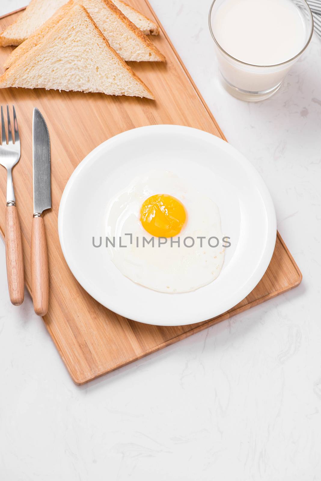 Top view of traditional healthy easy quick breakfast meal made of fried eggs served on a plate.