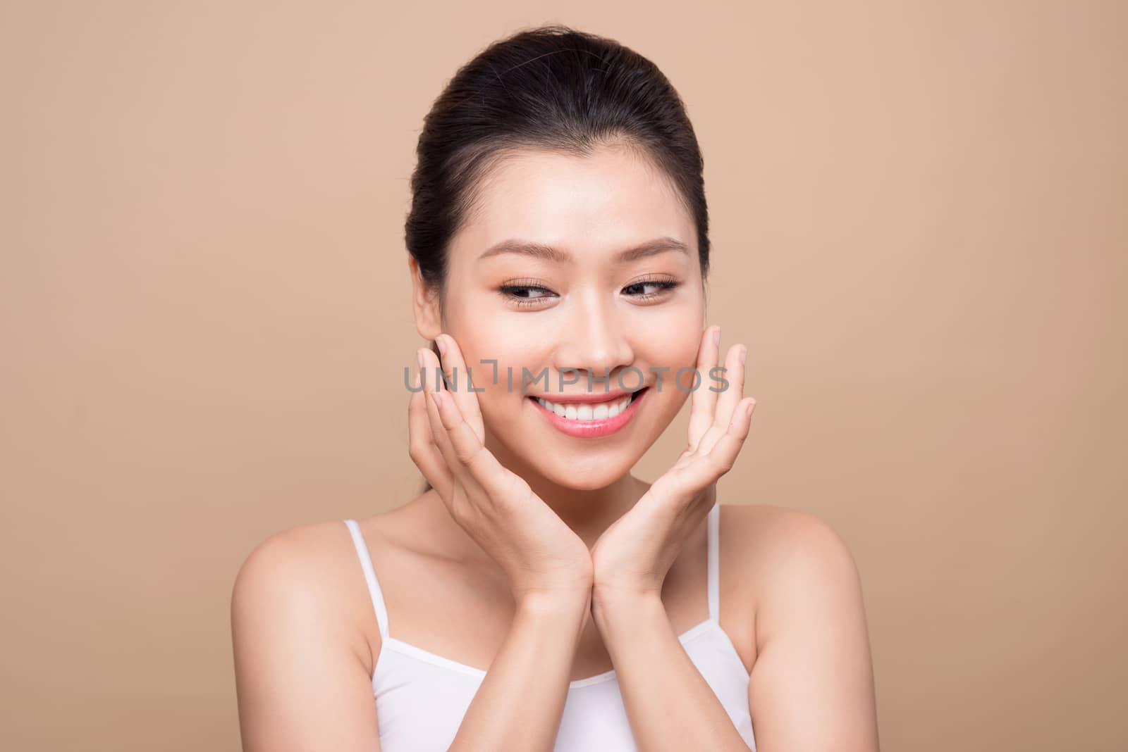 Beauty face. Facial treatment. Young asian woman with clean perfect skin touch her face.