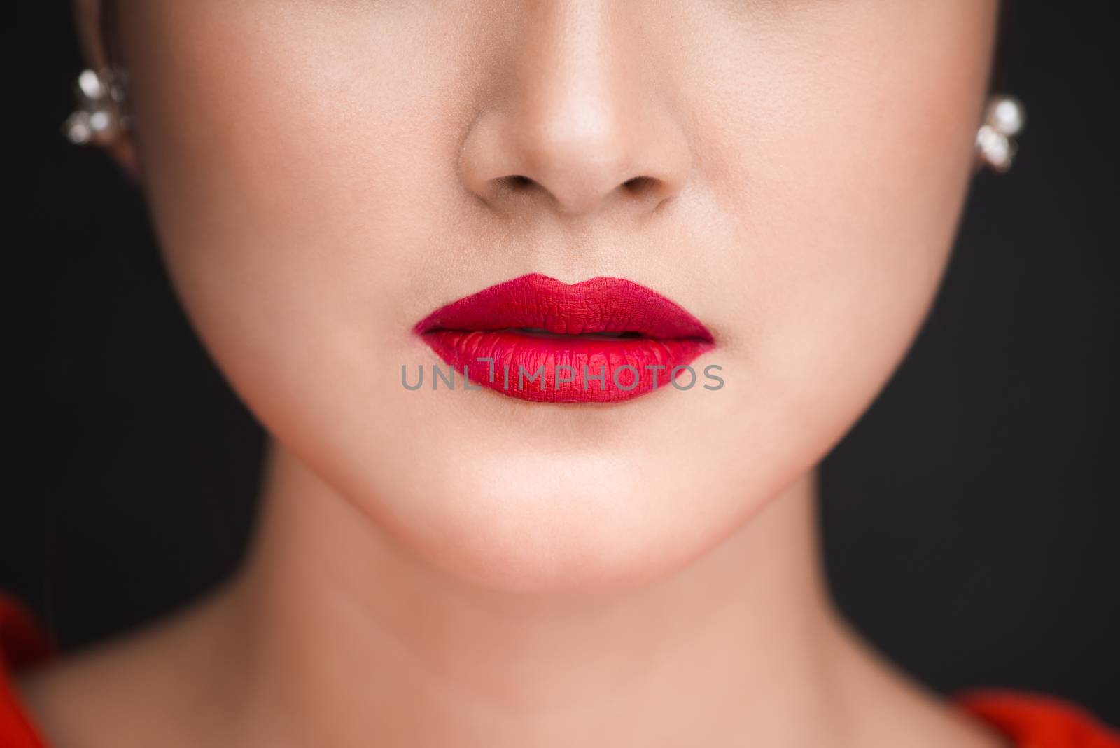 Beauty. Close up view of beautiful woman lips with red matt lips by makidotvn