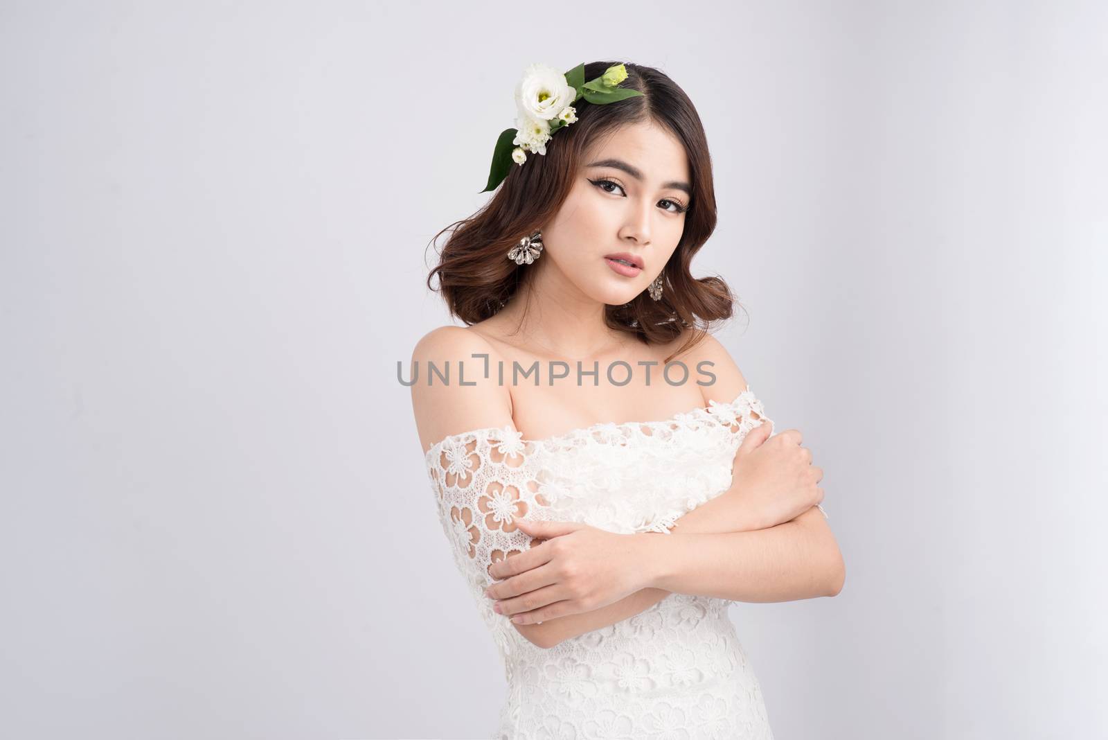 Beautiful asian woman bride on grey background. Closeup portrait by makidotvn