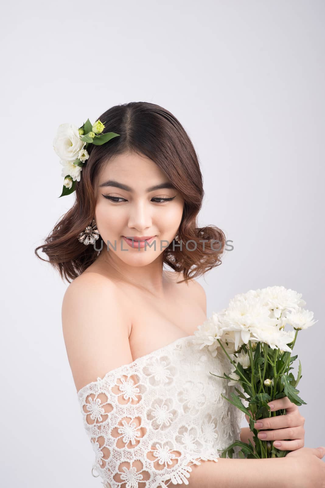 Beautiful asian woman bride on grey background. Closeup portrait by makidotvn