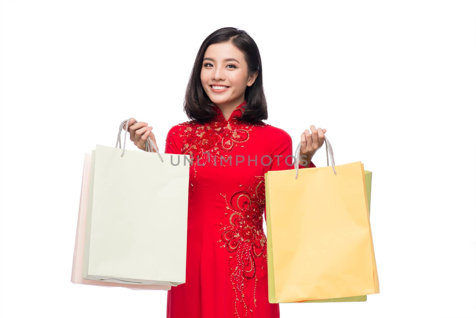 Charming Vietnamese Woman in Red Ao Dai Traditional Dress holdin by makidotvn