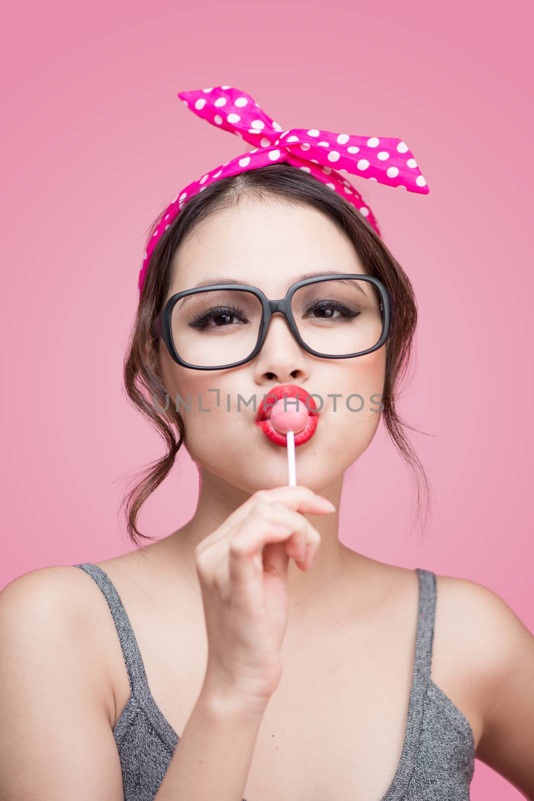 Portrait of beautiful asian woman eating heart shape lollipop, d by makidotvn