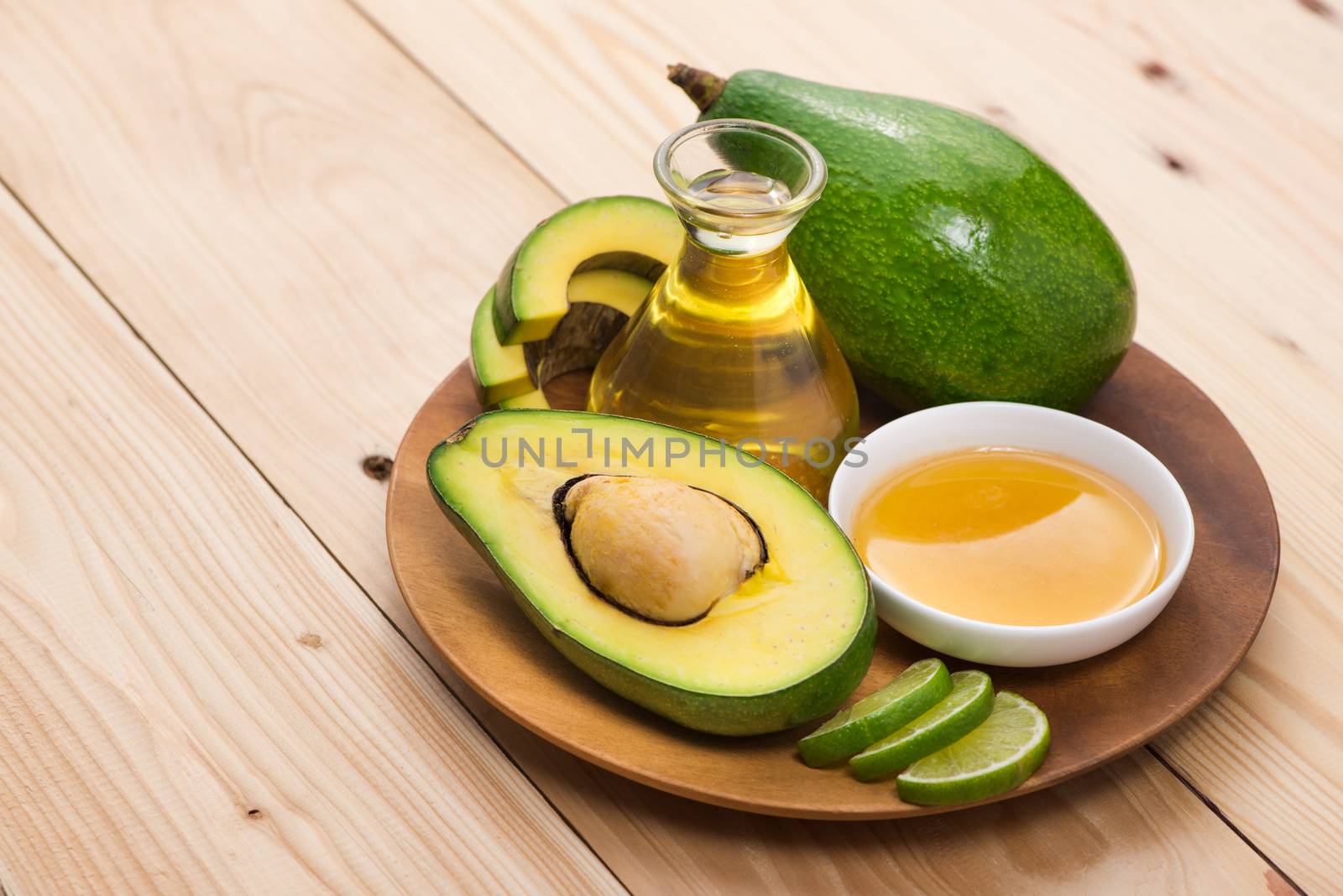 Healthy food concept. Fresh organic avocado oil with honey on table