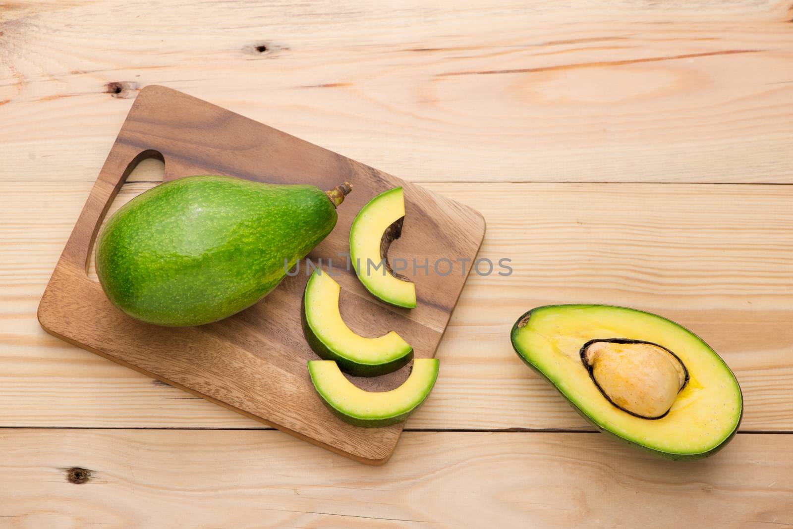 Healthy food concept. Fresh organic avocado on table by makidotvn