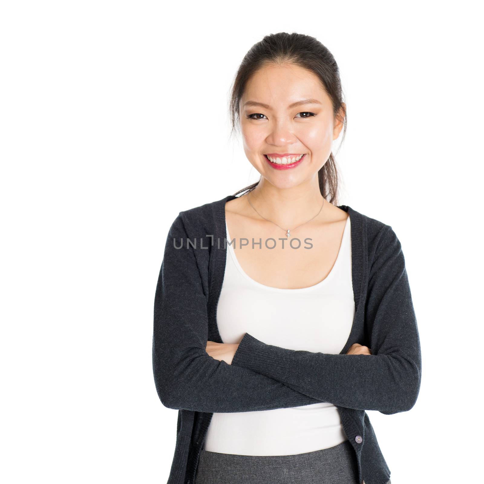 Portrait of young Asian girl arms crossed and smiling, isolated on white background.