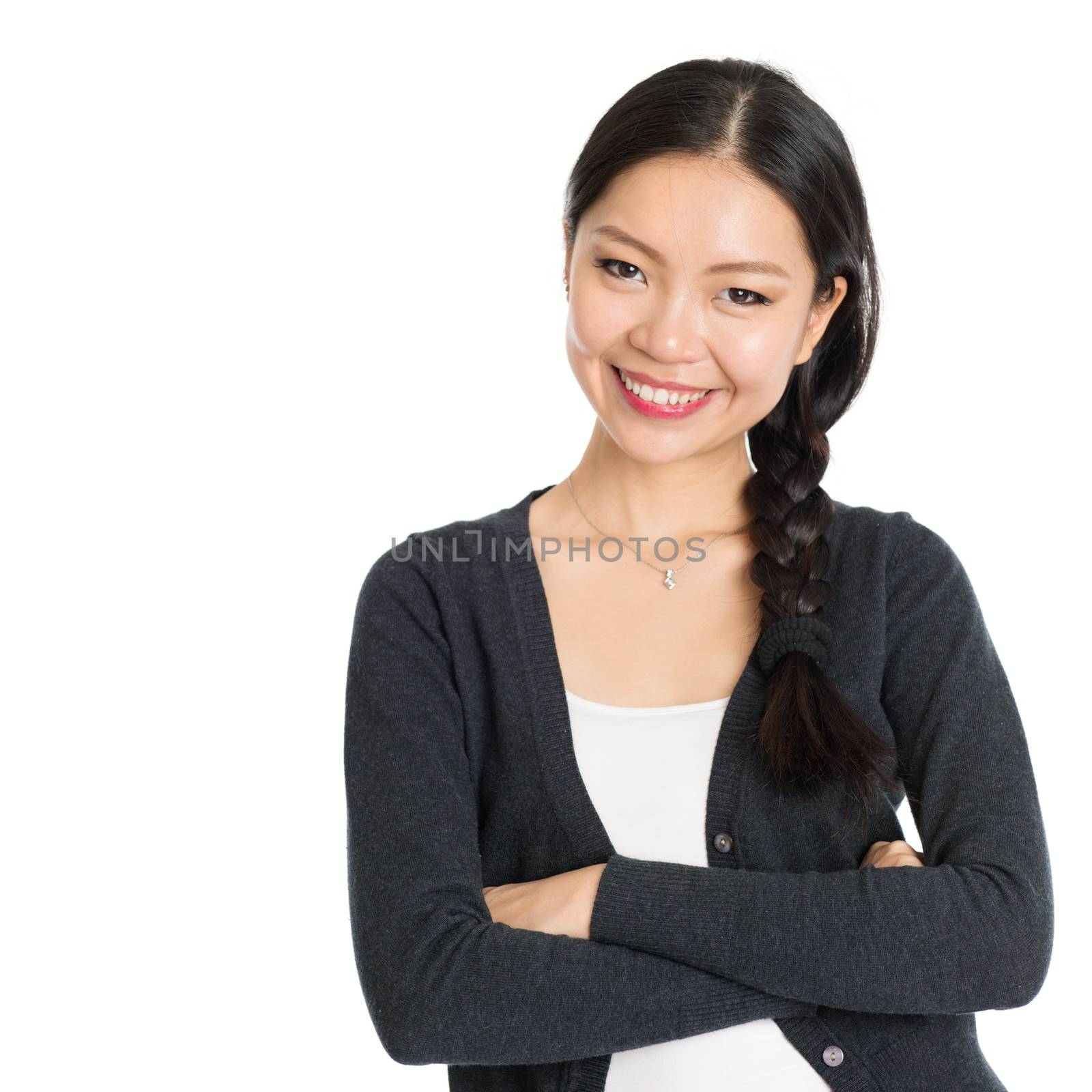 Portrait of young Asian female with braid hair, arms crossed and smiling, isolated on white background.