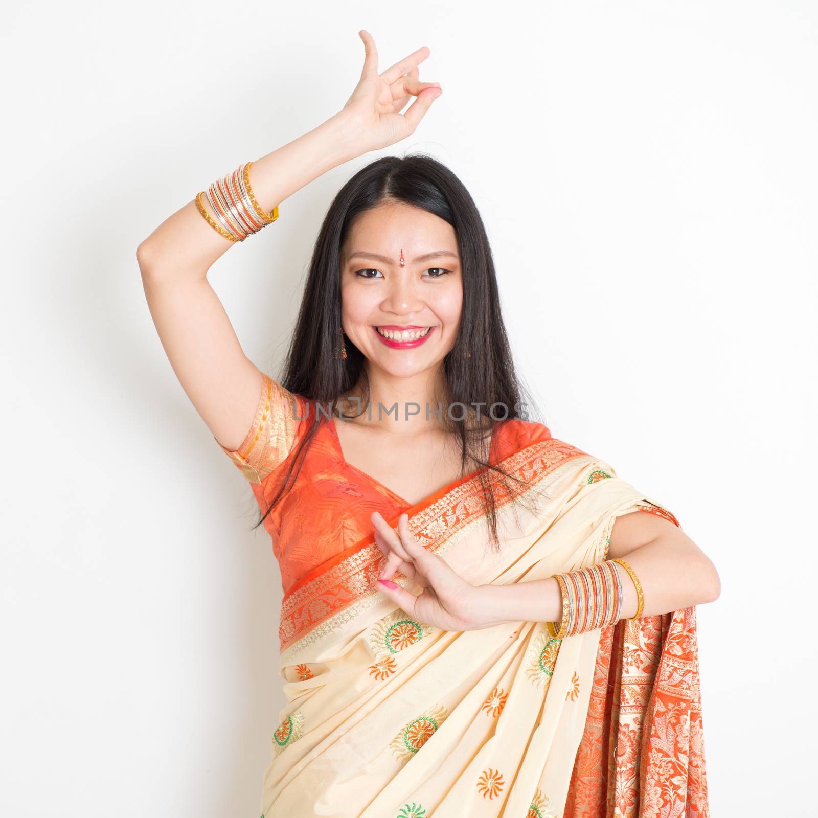 Young girl in Indian sari dress dancing by szefei