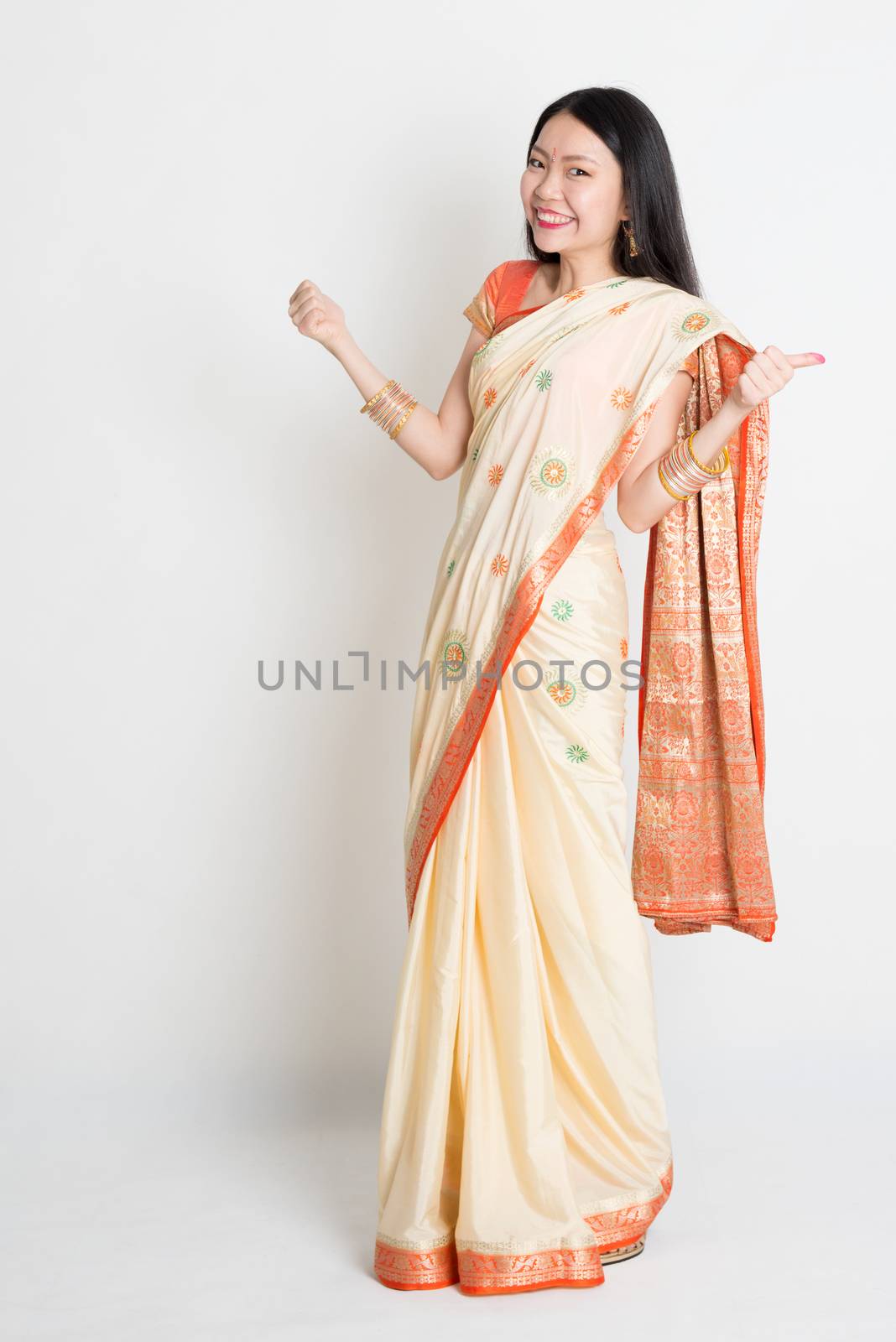 Woman in Indian sari dress thumbs up by szefei