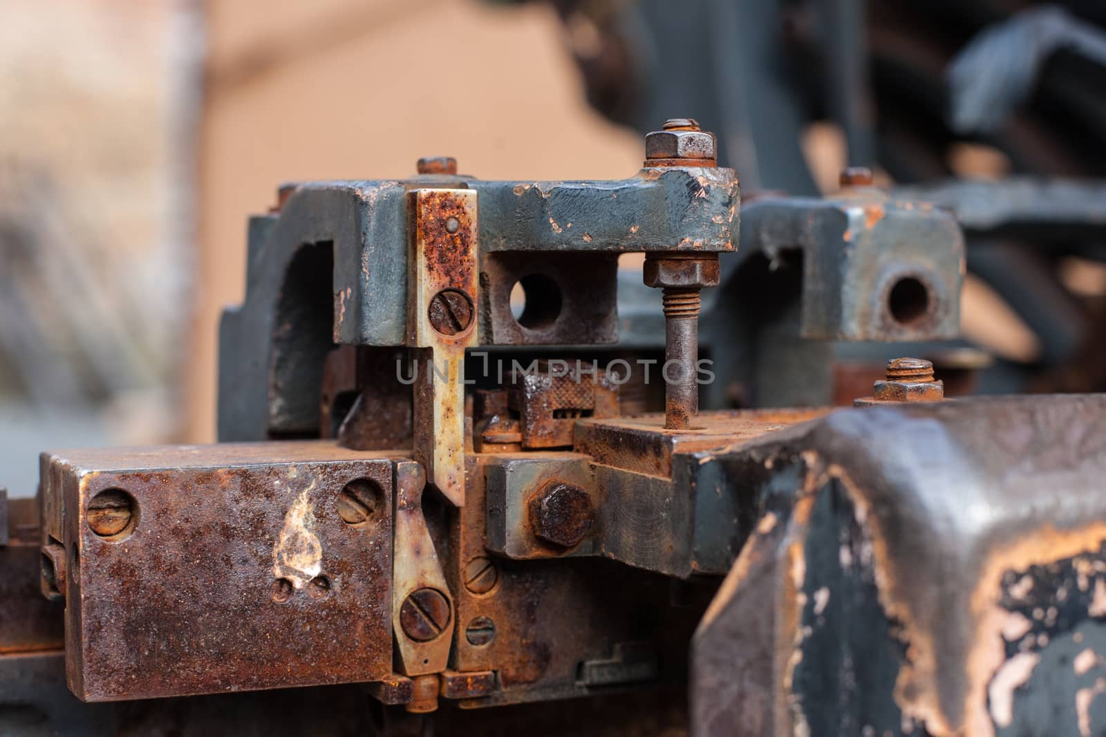Old rusty printing machine complex mechanism of metal with close up details