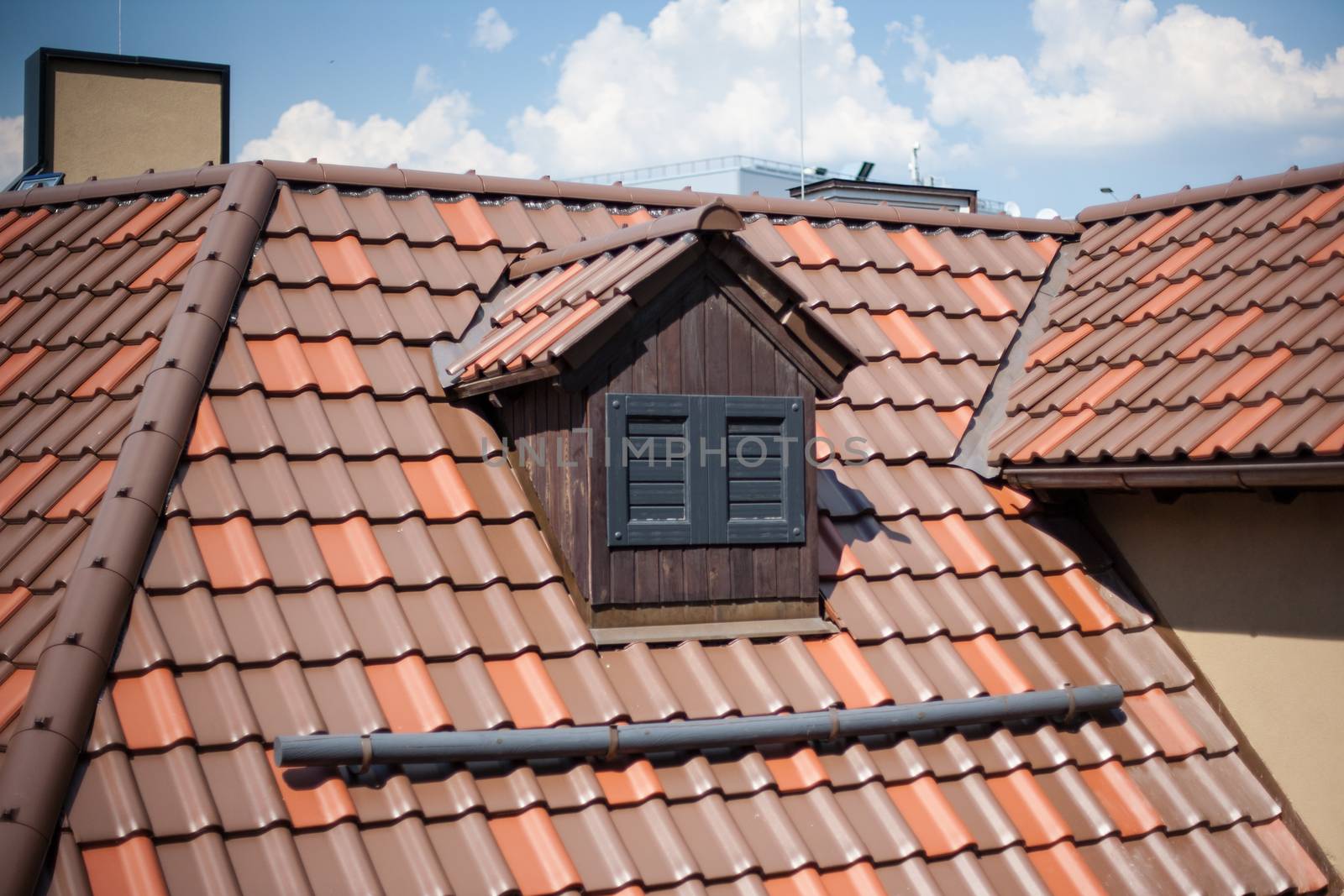 Detail of overlapping roofing tiles on a new build with window