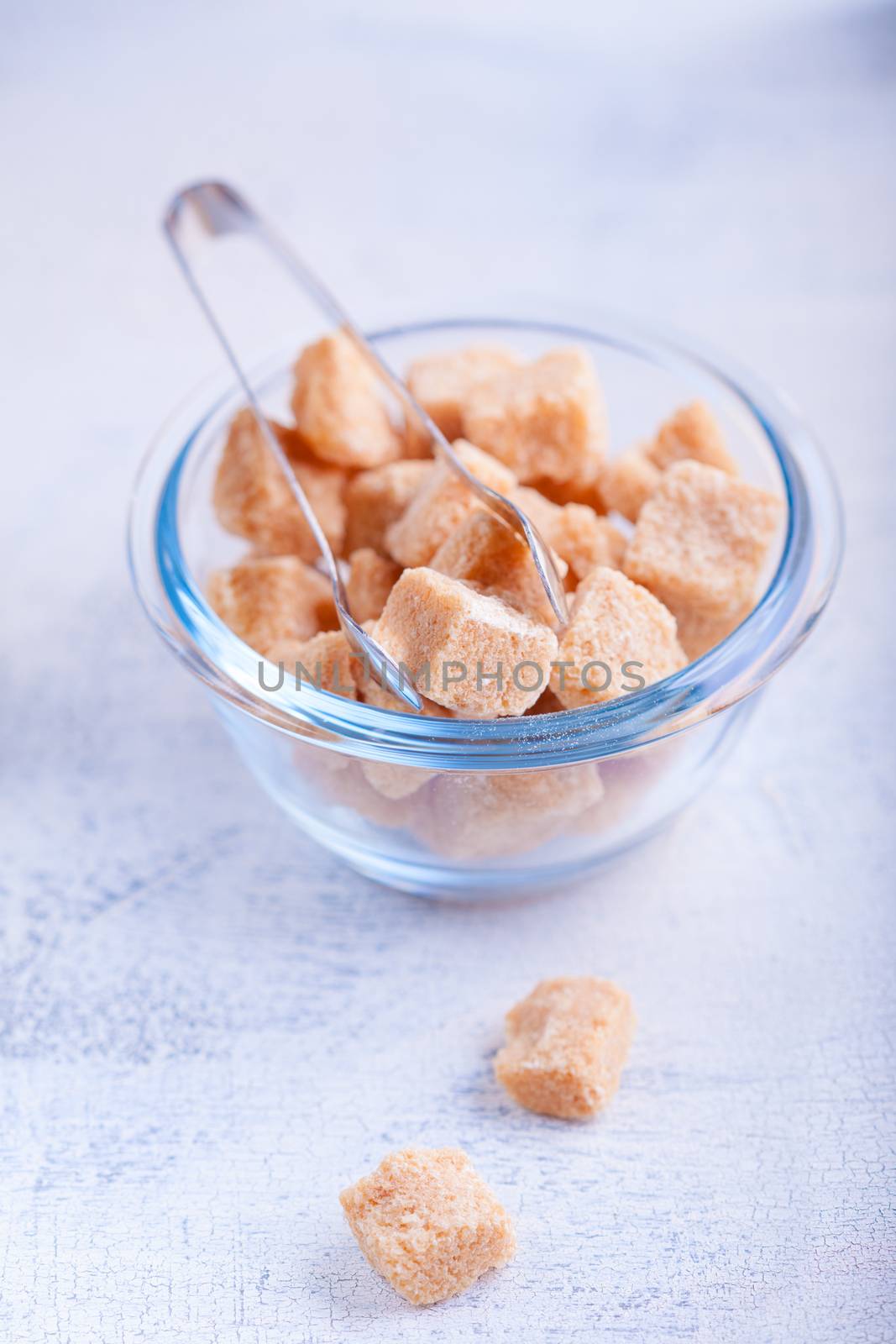 Brown cane sugar cubes in a glass bowl by supercat67