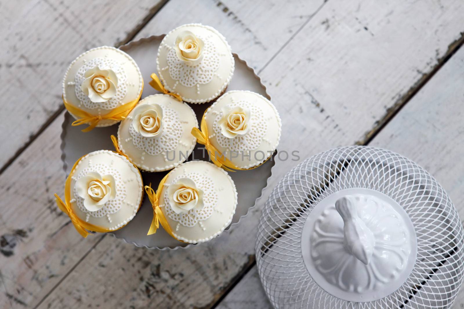 Beautiful wedding cupcakes with orange ribbon