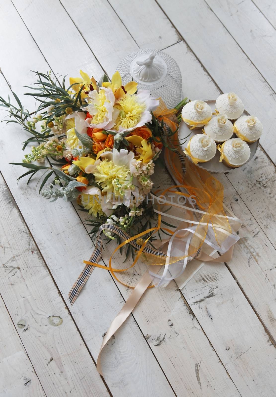 Beautiful cakes and bridal bouquet in orange tones