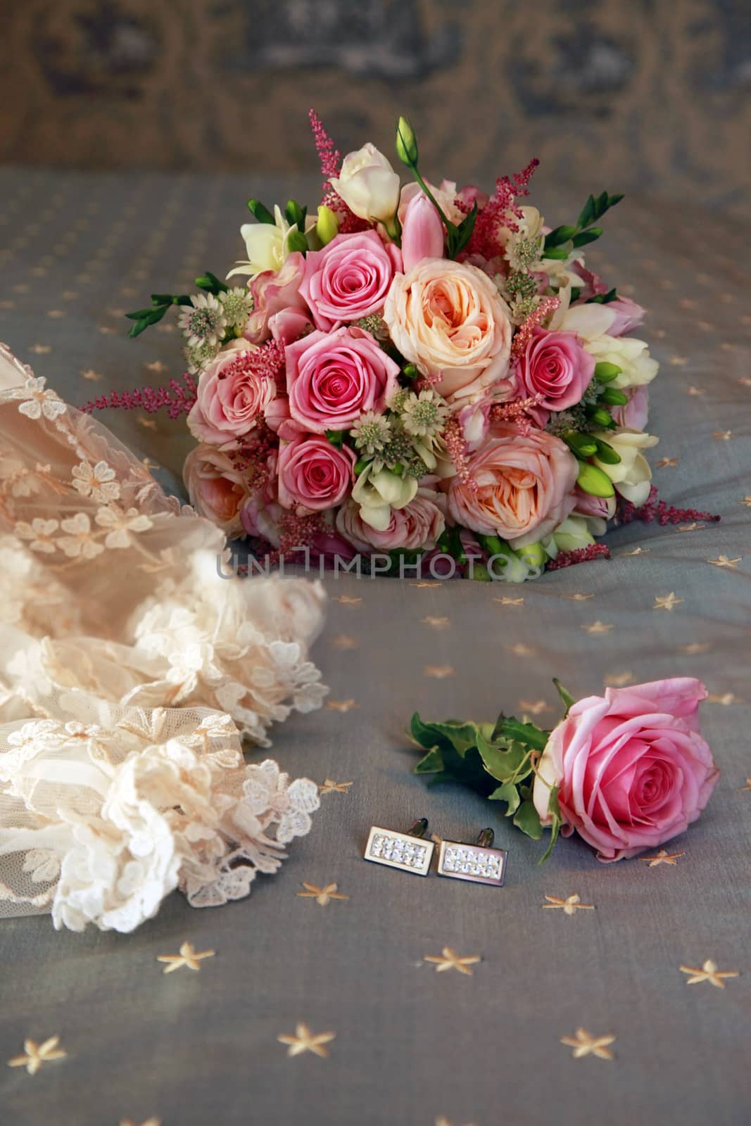 Beautiful wedding bouquet from pink roses and groom cufflinks