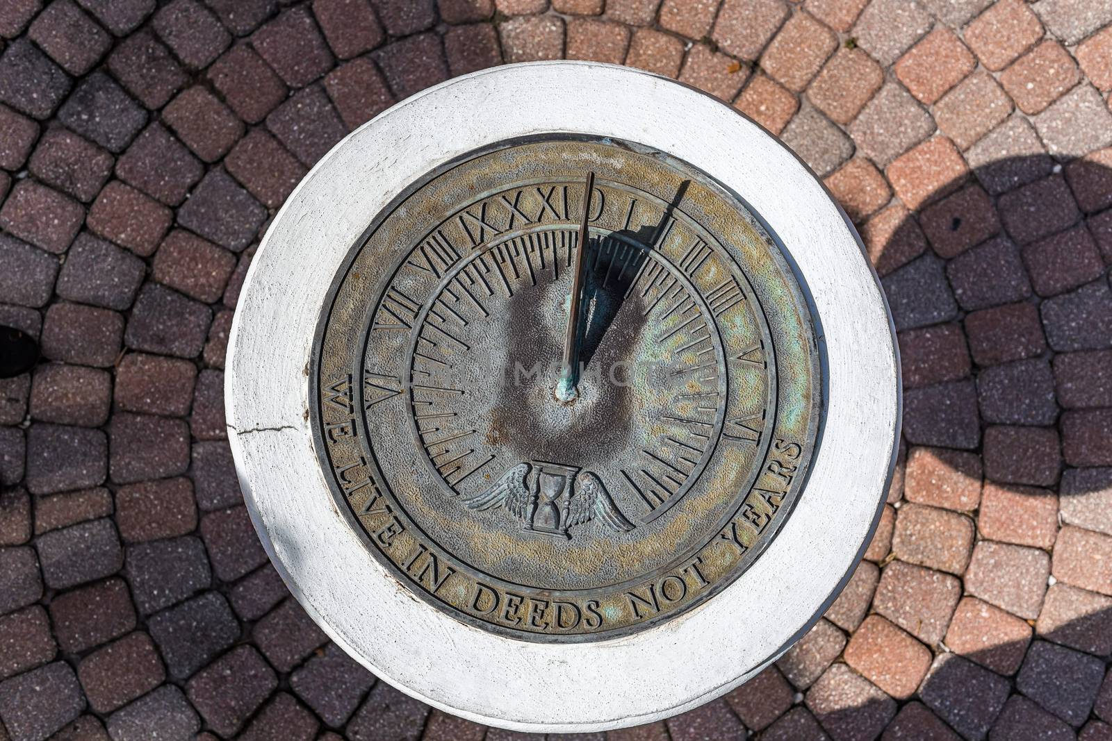 A sundial shows the time in the early afternoon.