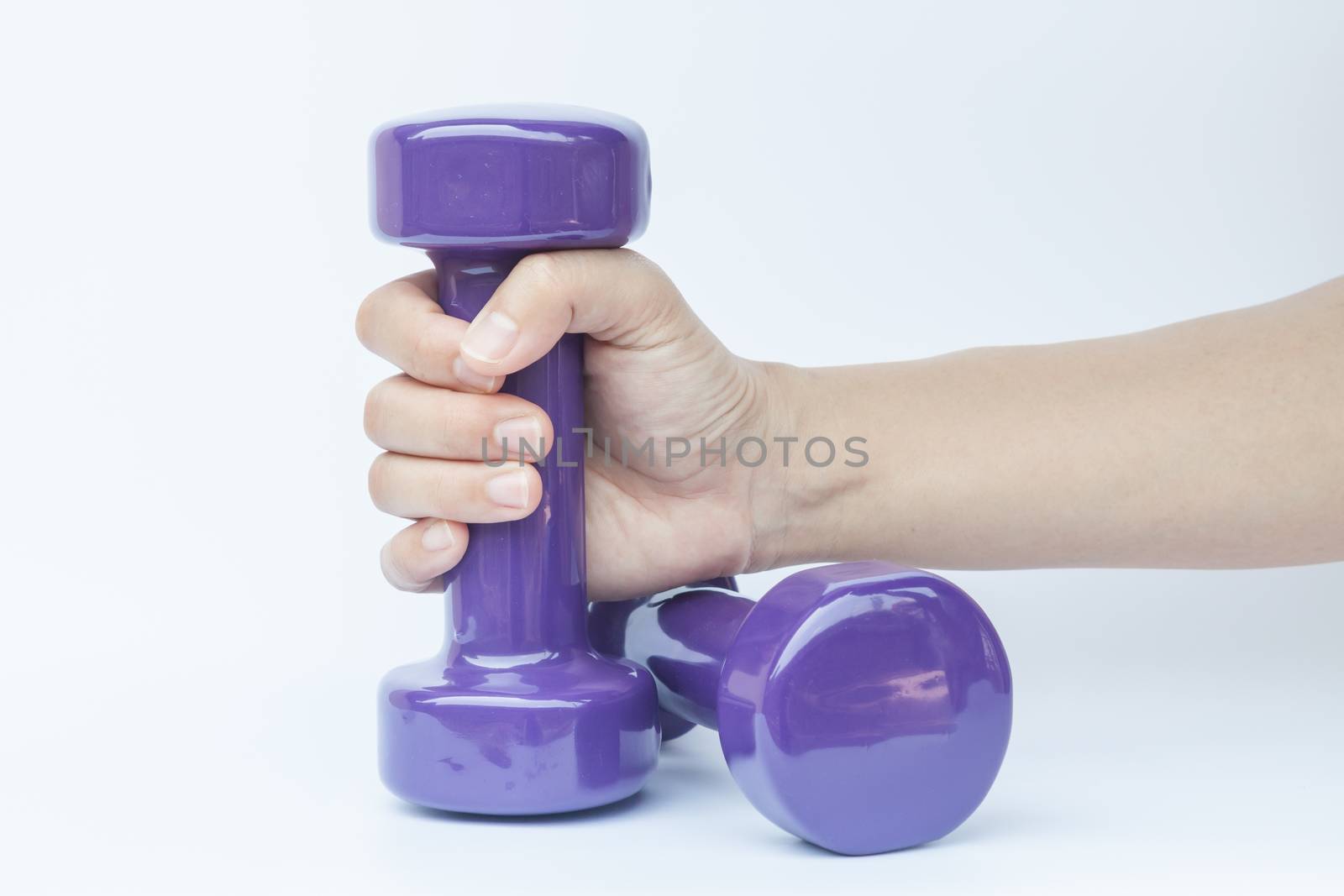 Woman hand holding dumbbell weight isolated on white background, stock photo