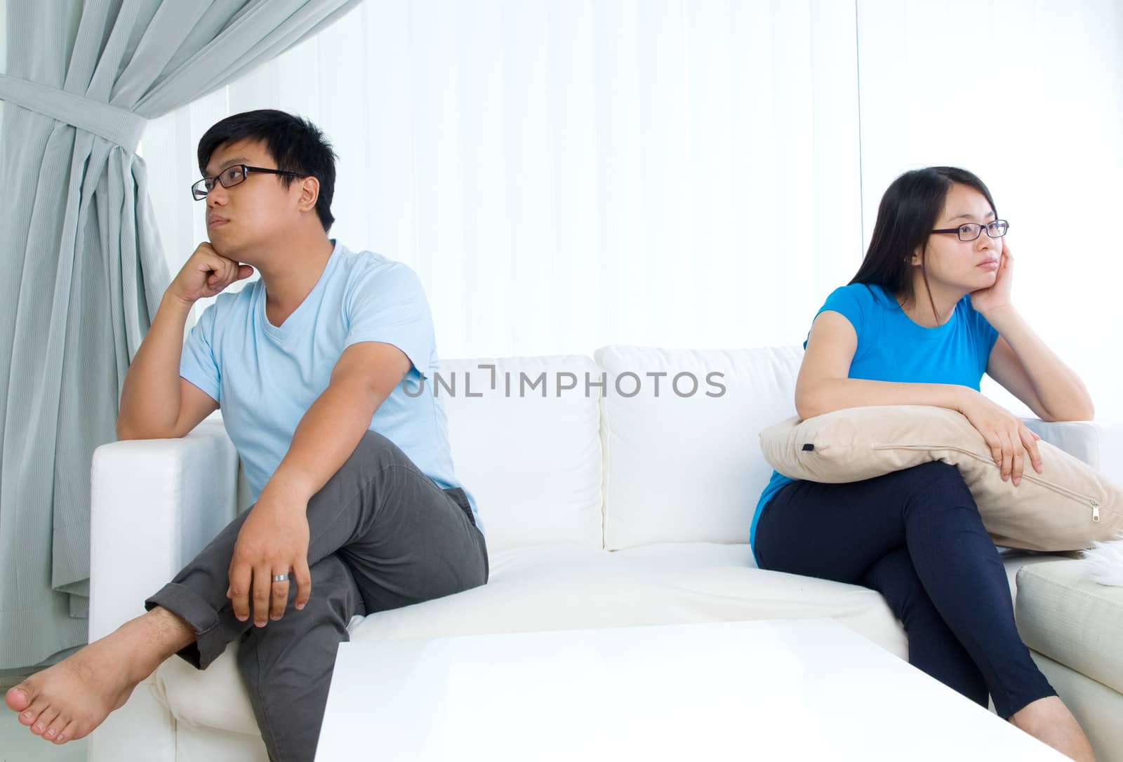 Asian young Couple having argument in the living room