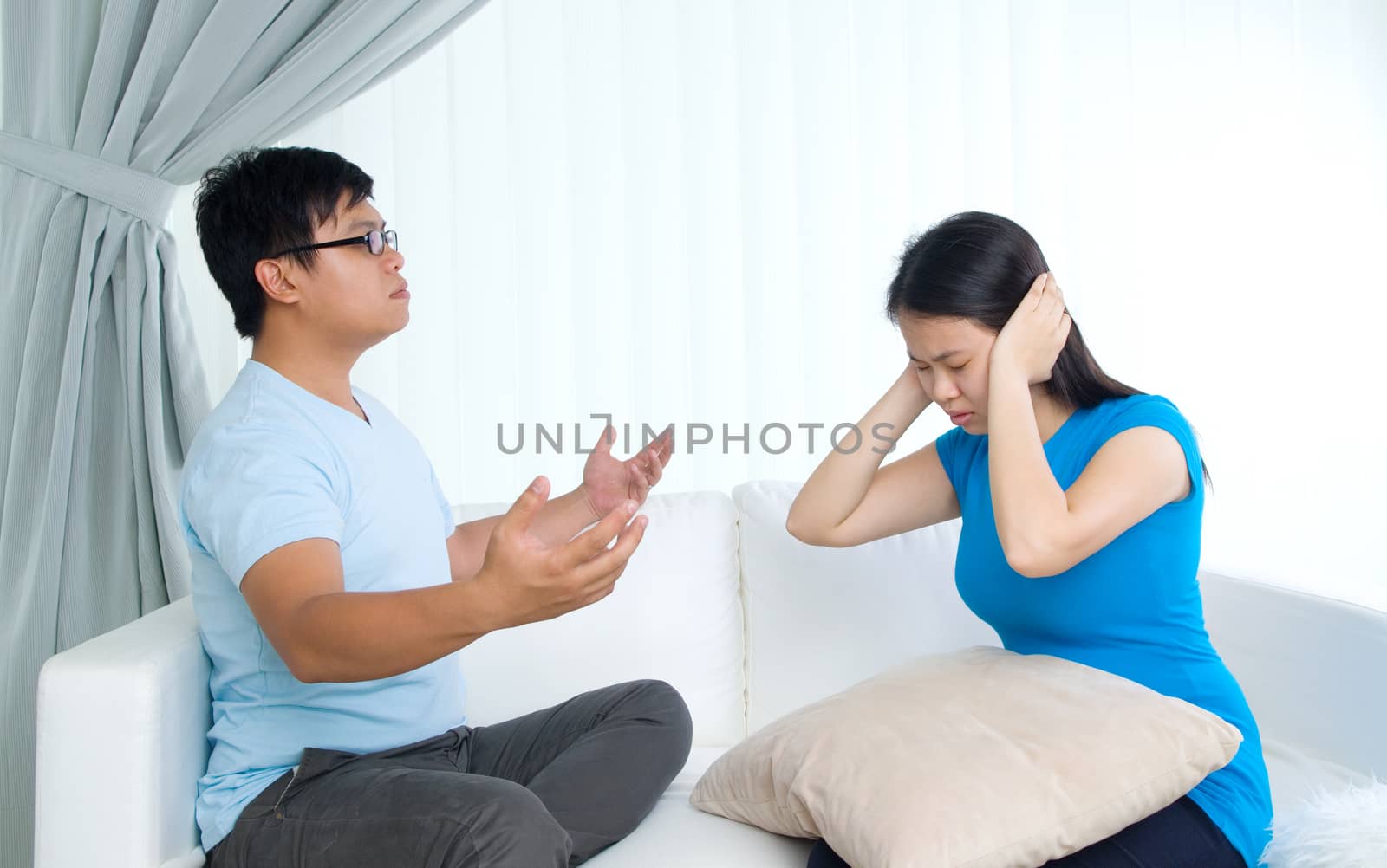 Asian young Couple having argument in the living room