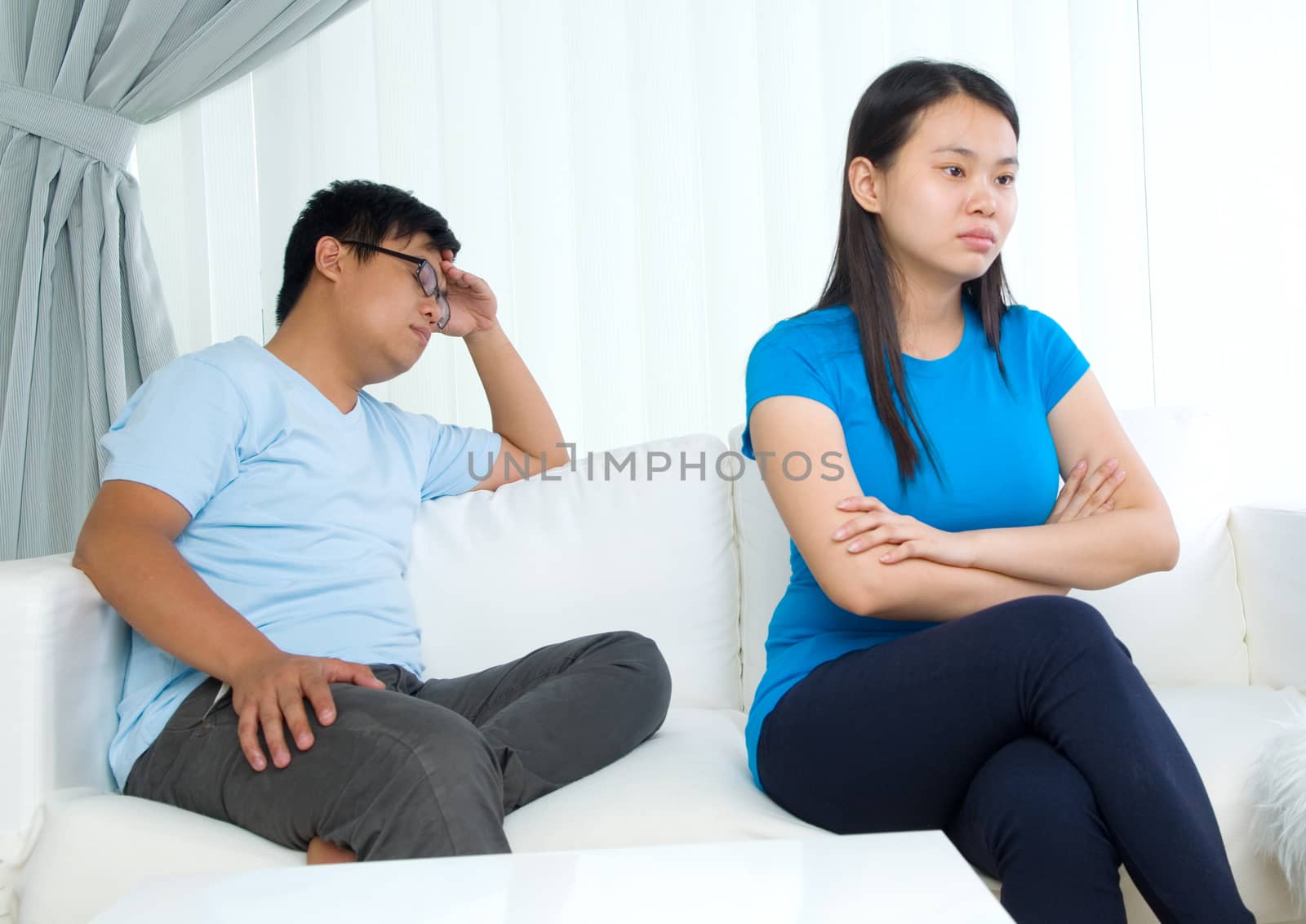 Asian young Couple having argument in the living room