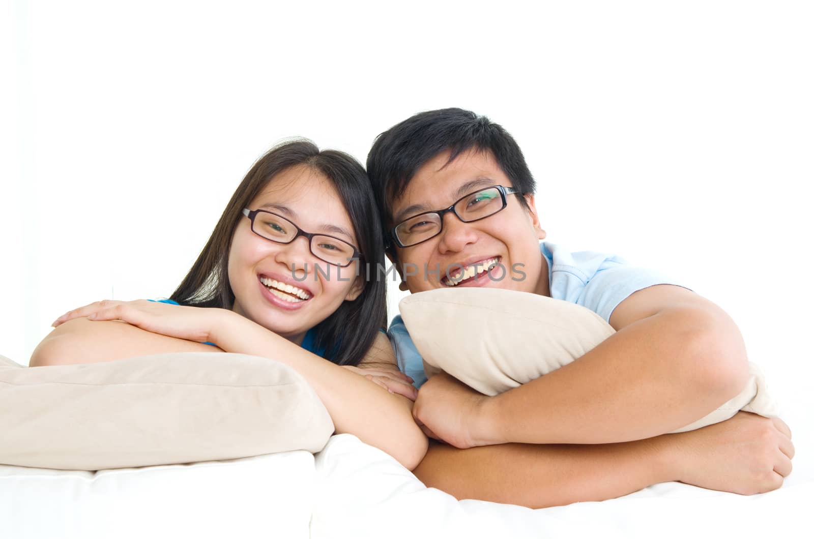 sweet young couple sitting in sofa