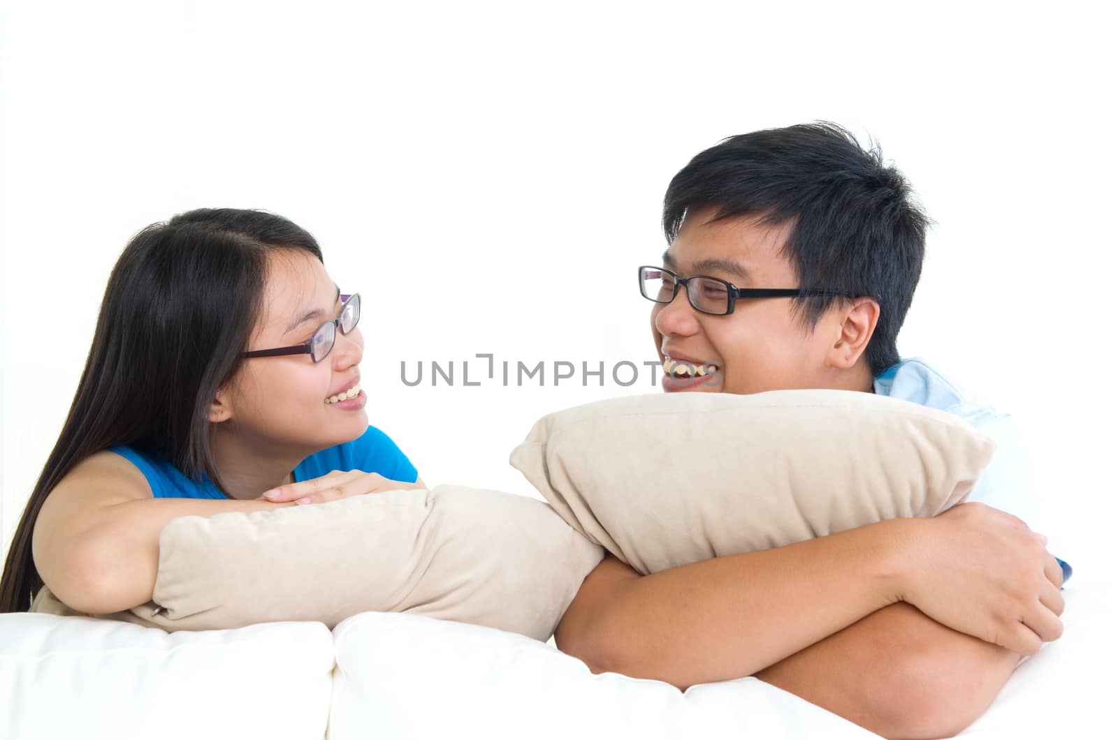 sweet young couple sitting in sofa