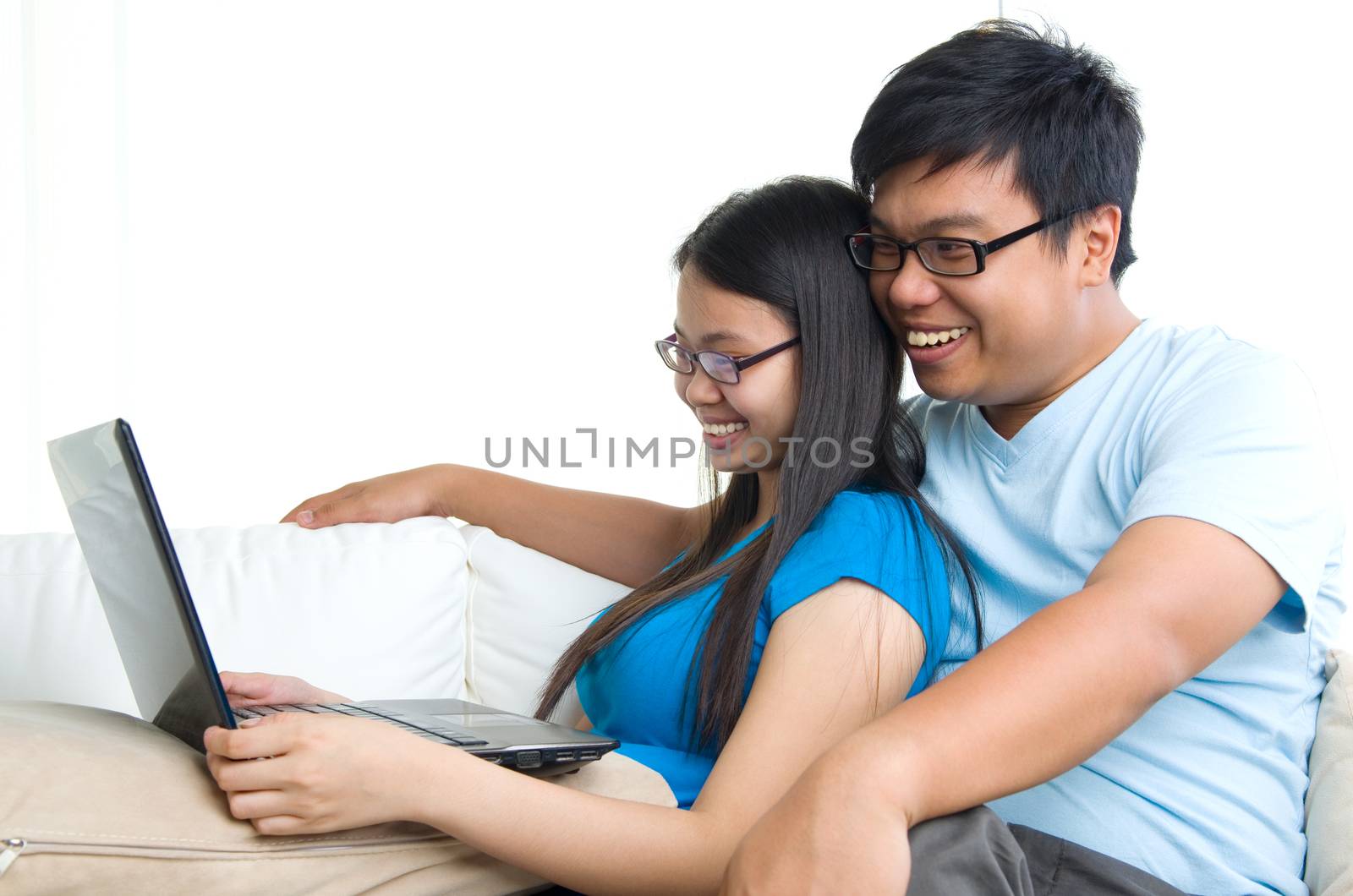 young Couple on sofa with tablet computer