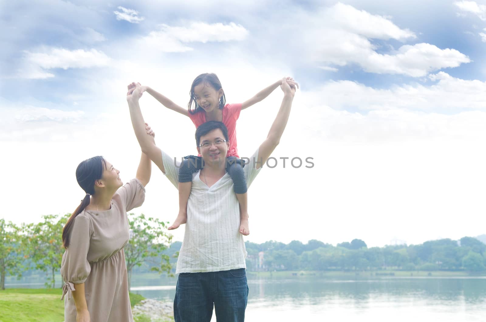 Happy Asian Family enjoying family time together in the park