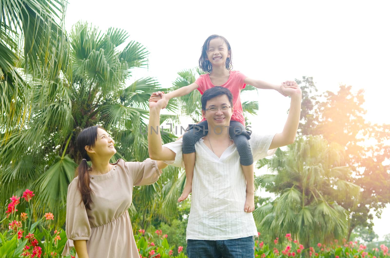 Happy Asian Family enjoying family time together in the park