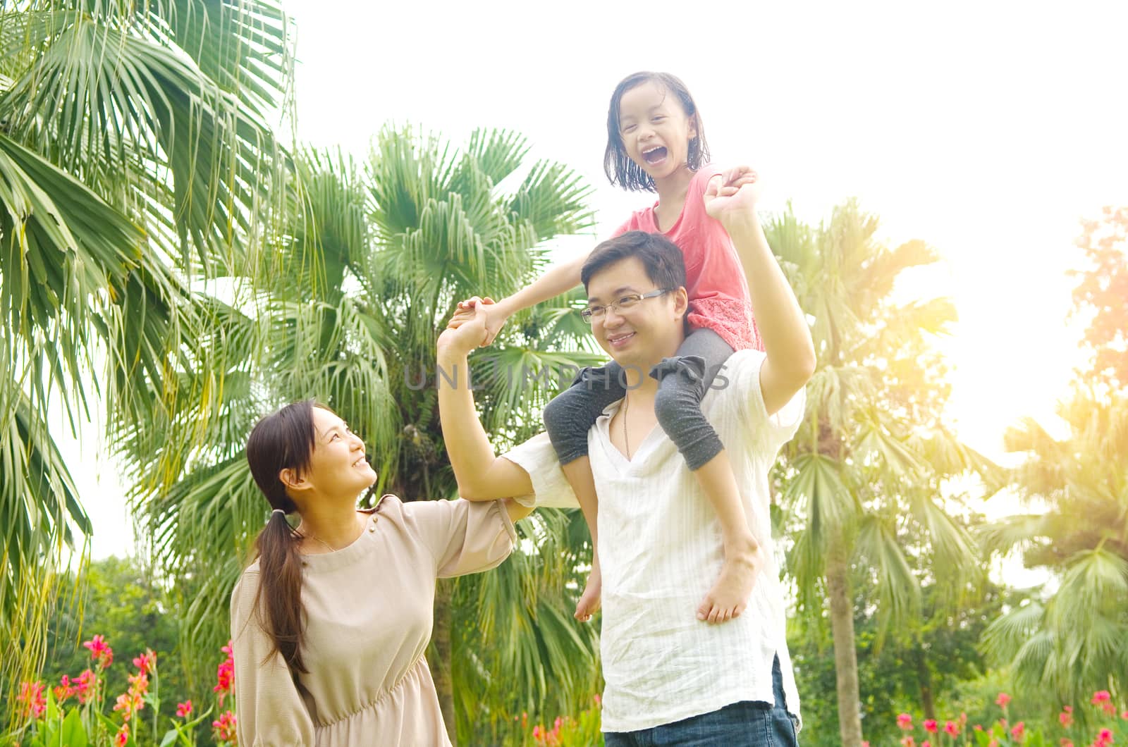 Happy Asian Family enjoying family time together in the park