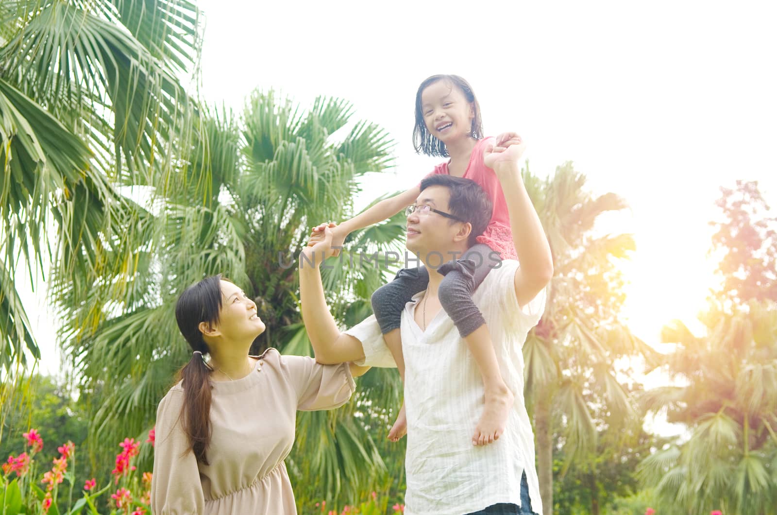 Happy Asian Family enjoying family time together in the park