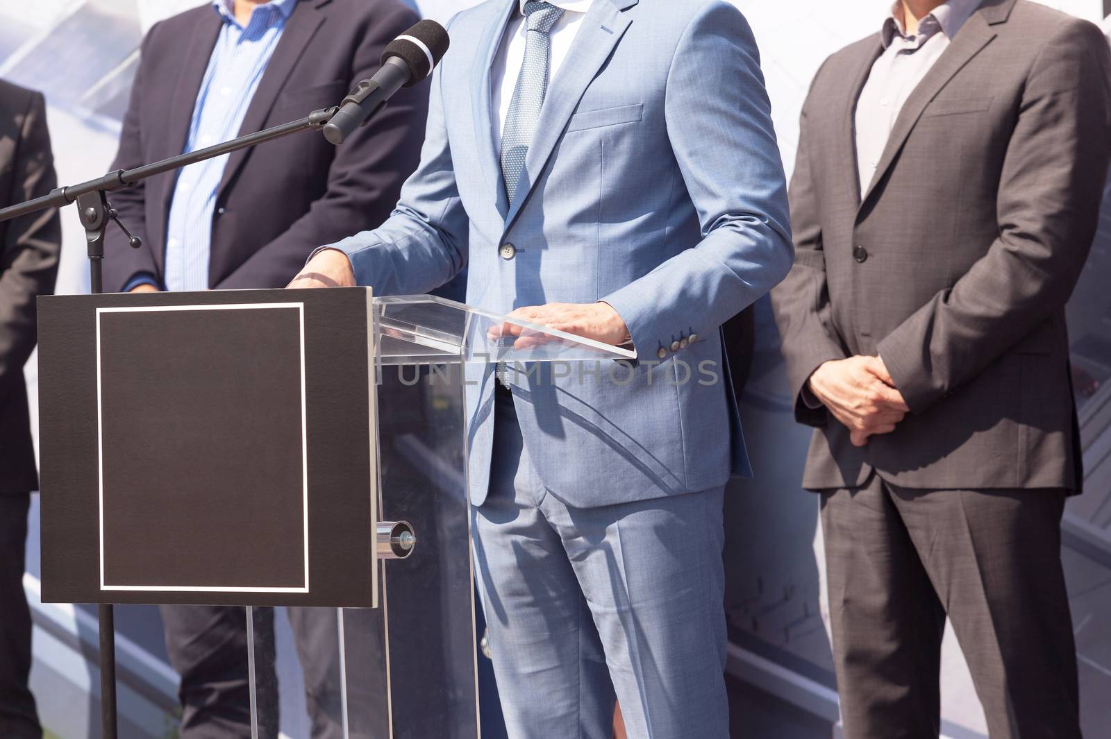 Political rally. Businessman or politician is giving a speech. by wellphoto