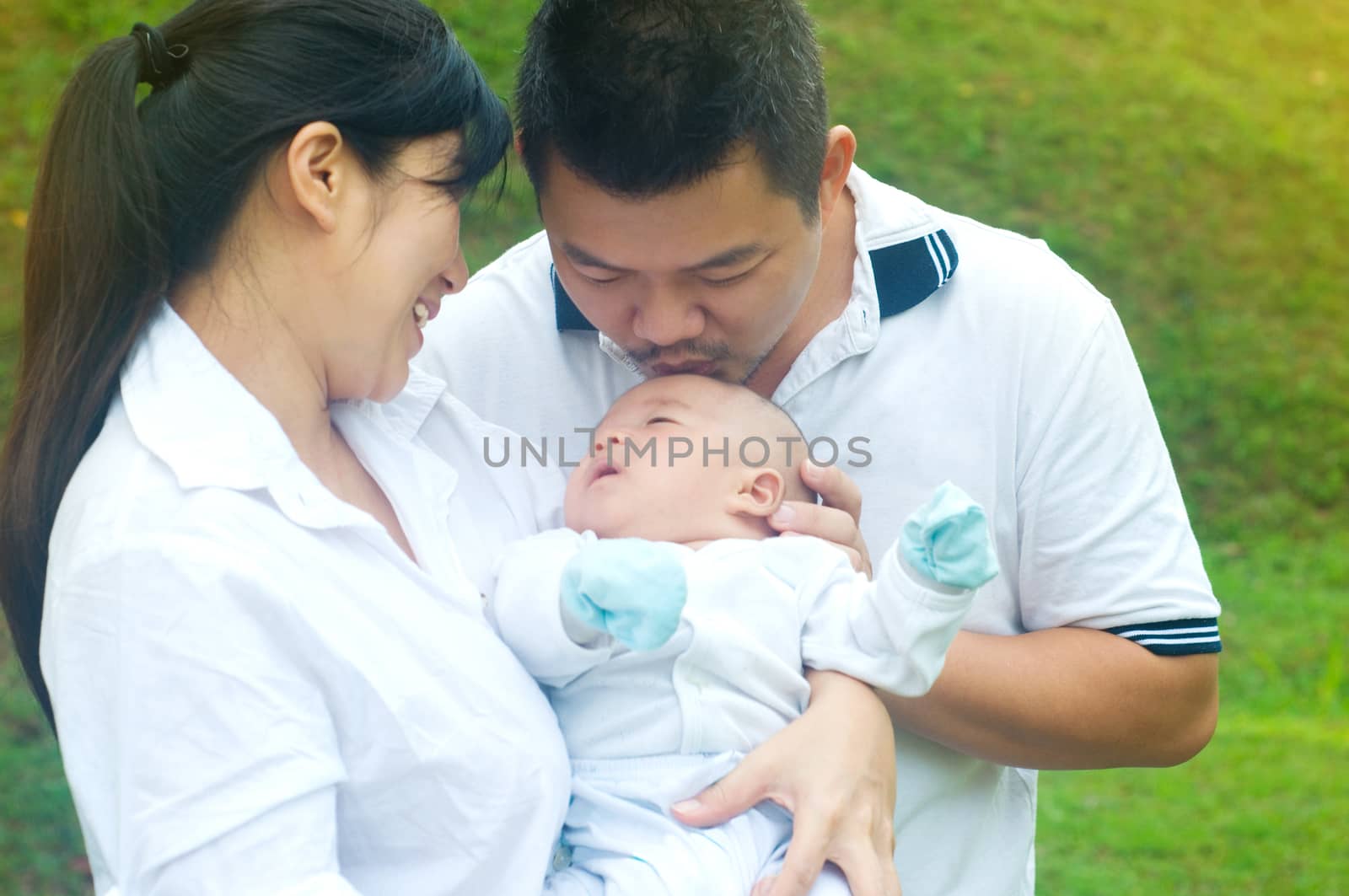 outdoor portrait of happy asian family