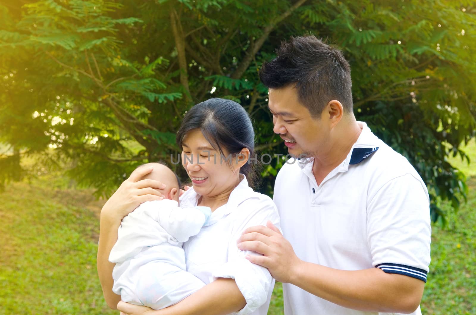 outdoor portrait of happy asian family