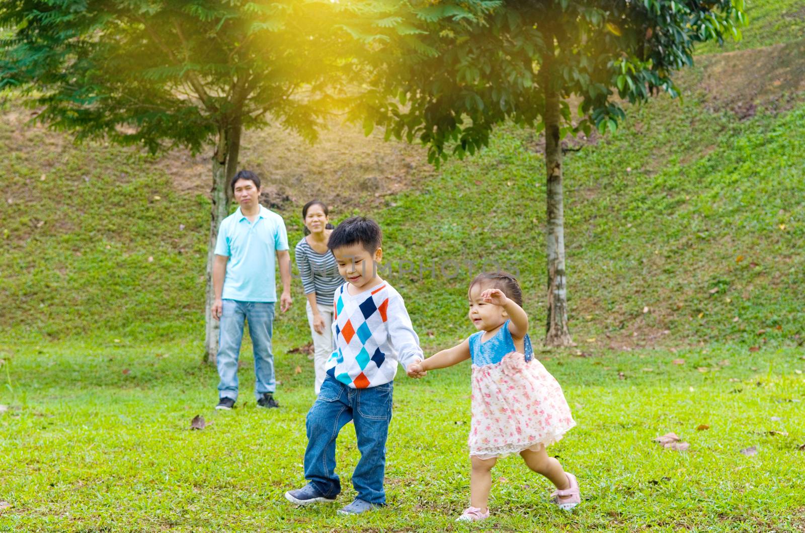 Outdoor portrait of happy asian family