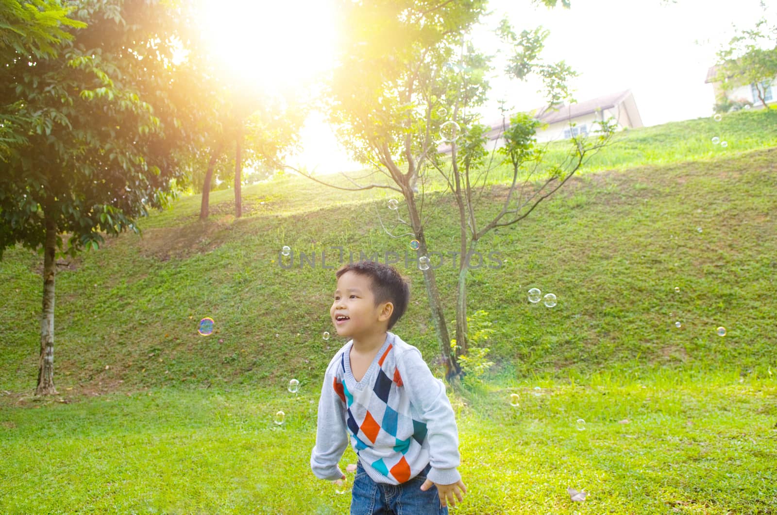 Asian boy playing bubbles outdoor