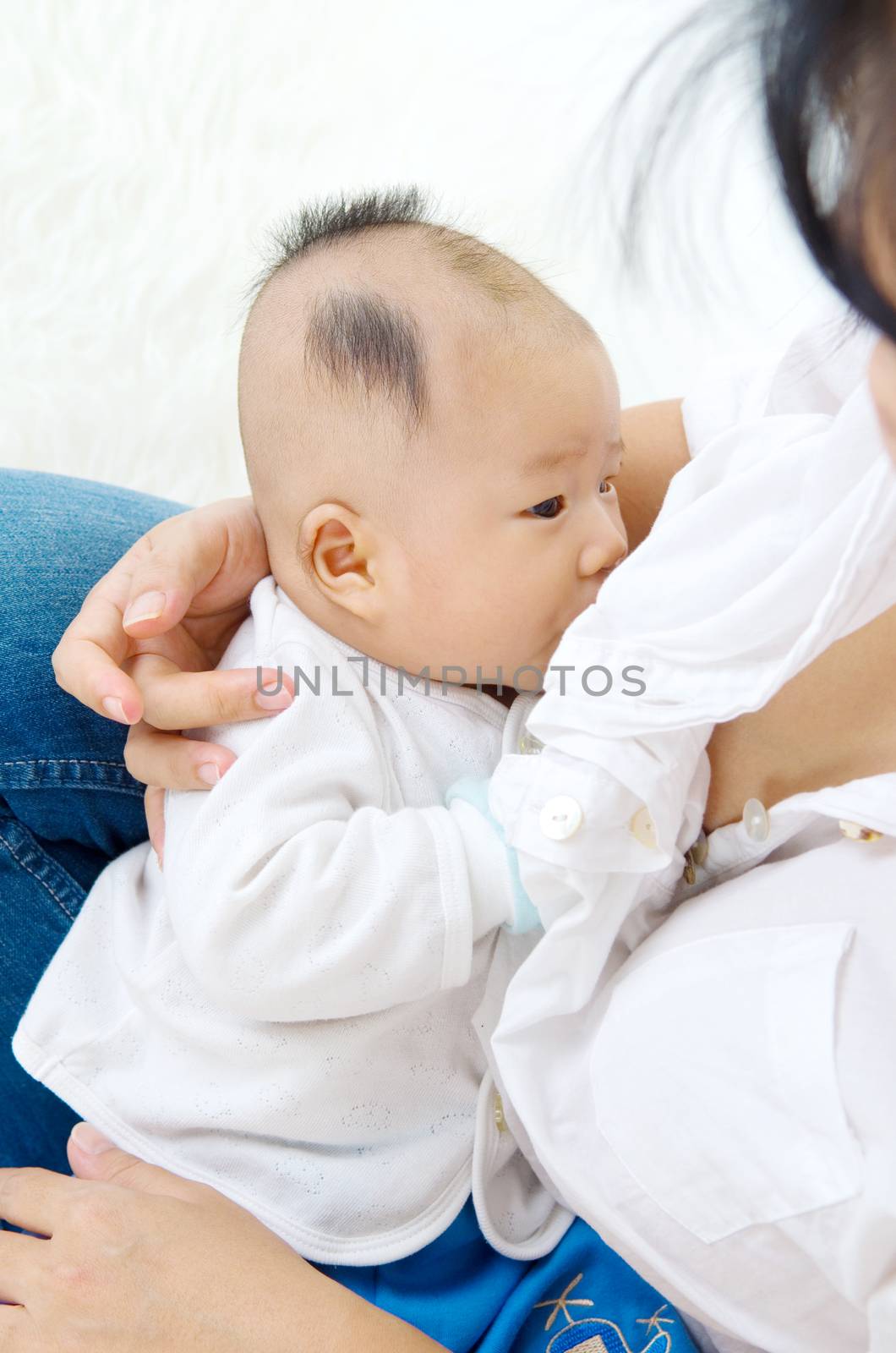 Asian mother breastfeeding her baby boy