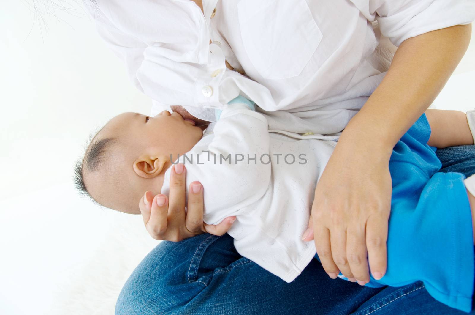 Asian mother breastfeeding her baby boy