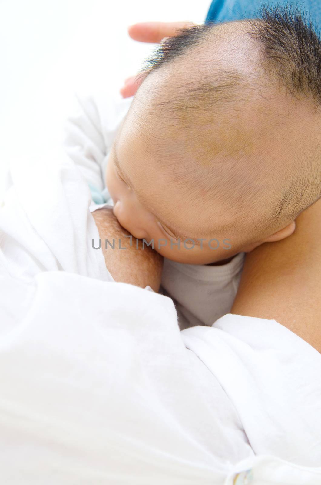 Asian mother breastfeeding her baby boy