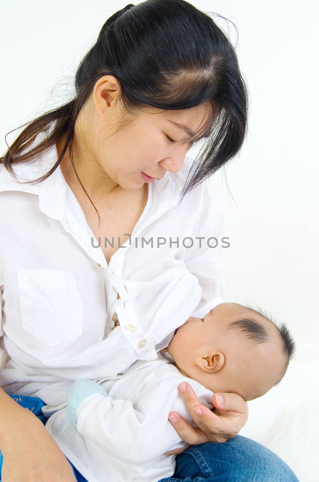 Asian mother breastfeeding her baby boy