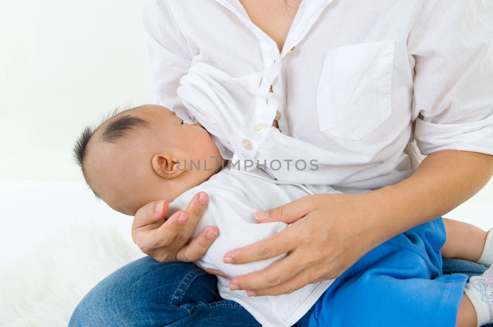 Asian mother breastfeeding her baby boy